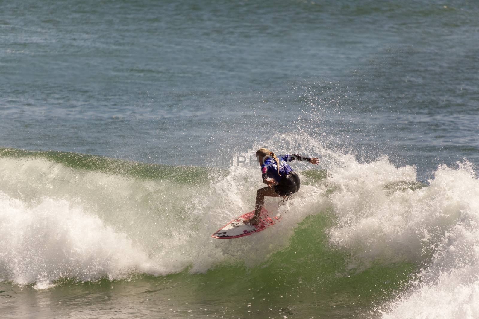 Professional female surfer compete on the Burleigh Pro 2013 by Imagecom