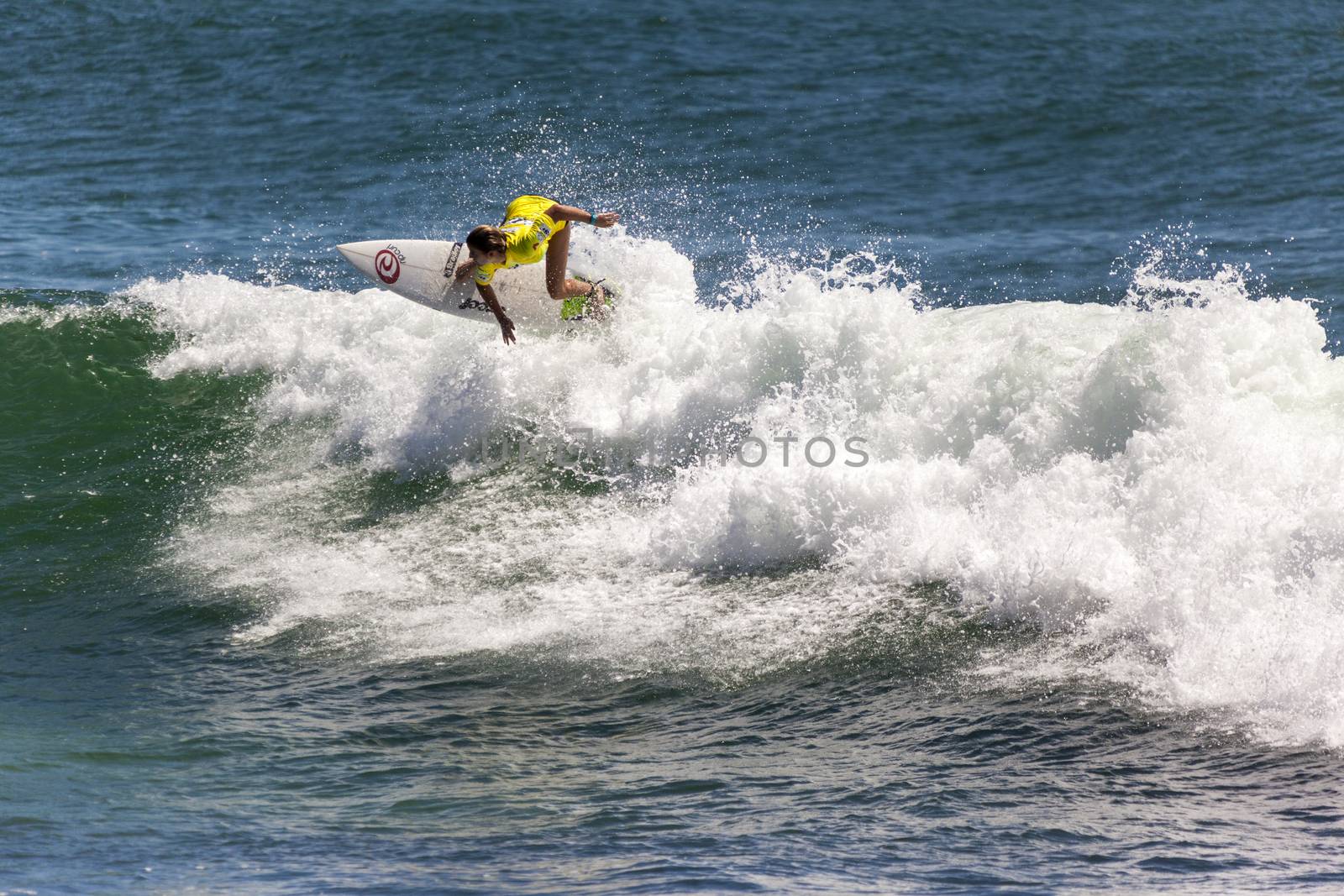 Professional female surfer compete on the Burleigh Pro 2013 by Imagecom