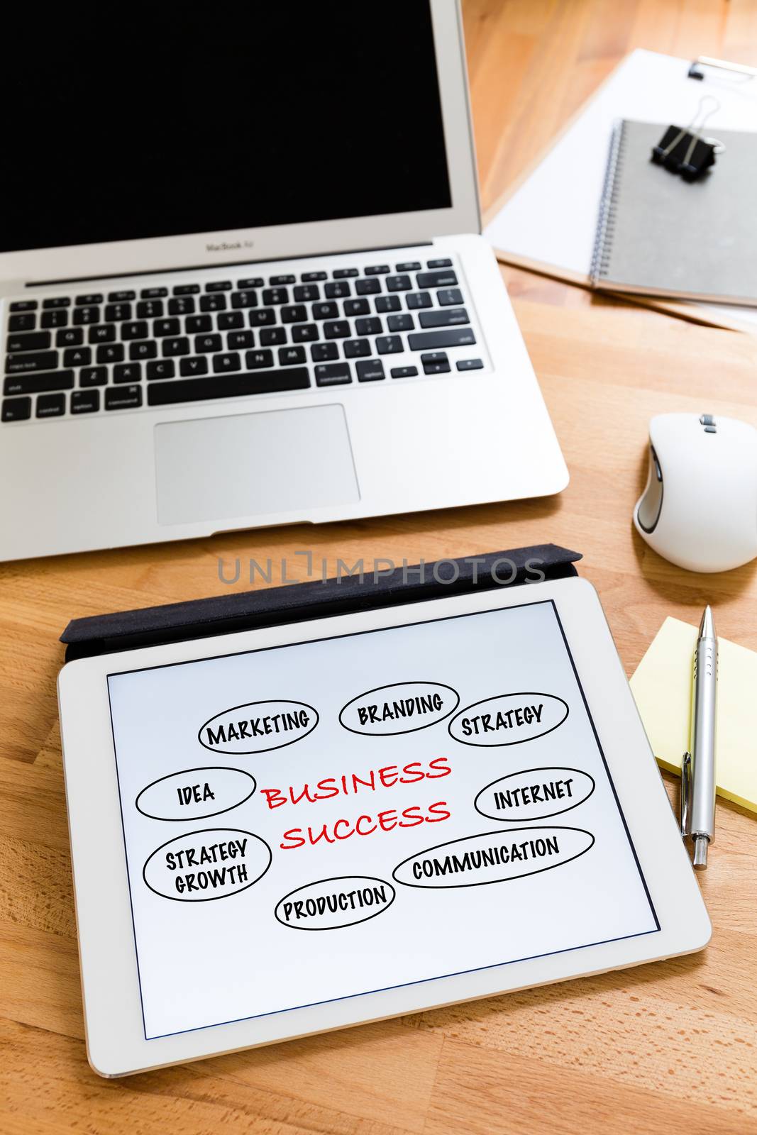 Business working desk with tablet showing marketing success concept