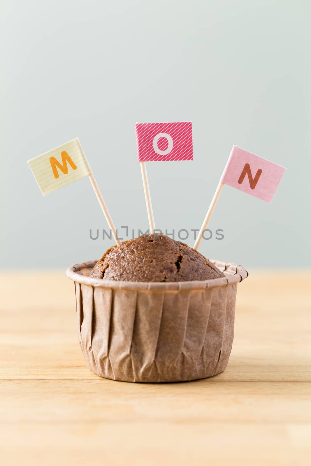 Chocolate muffins with small flag of a word mon