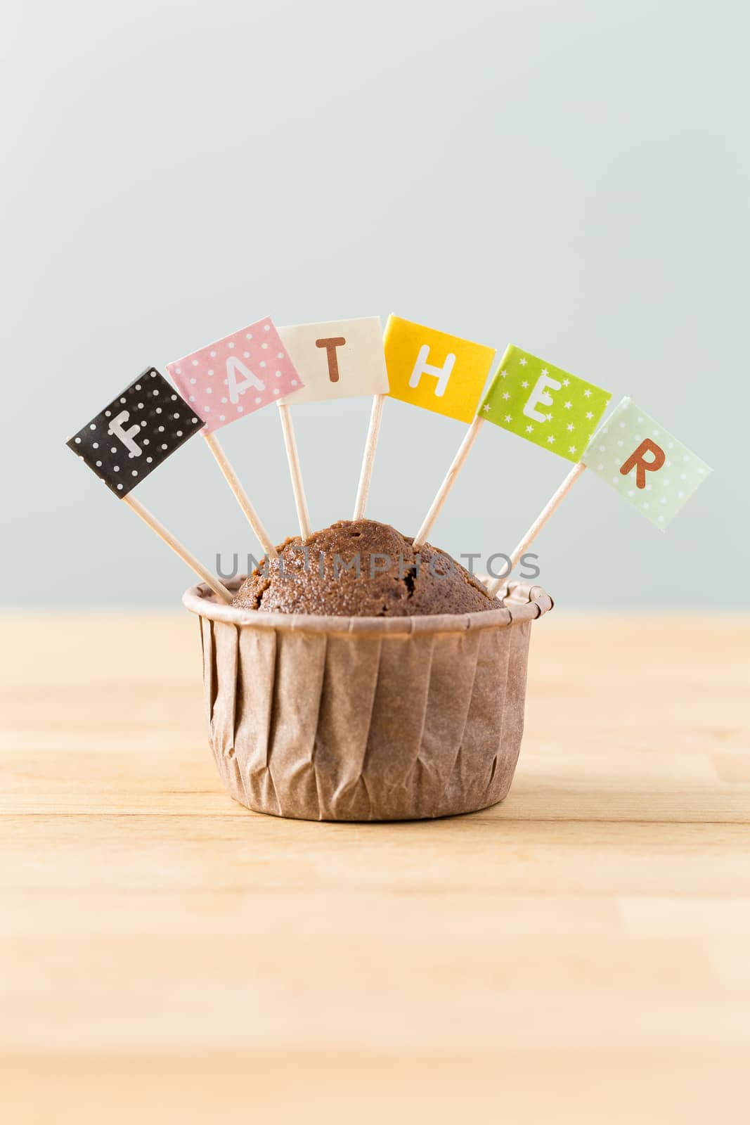 Chocolate muffins with small flag of a word father
