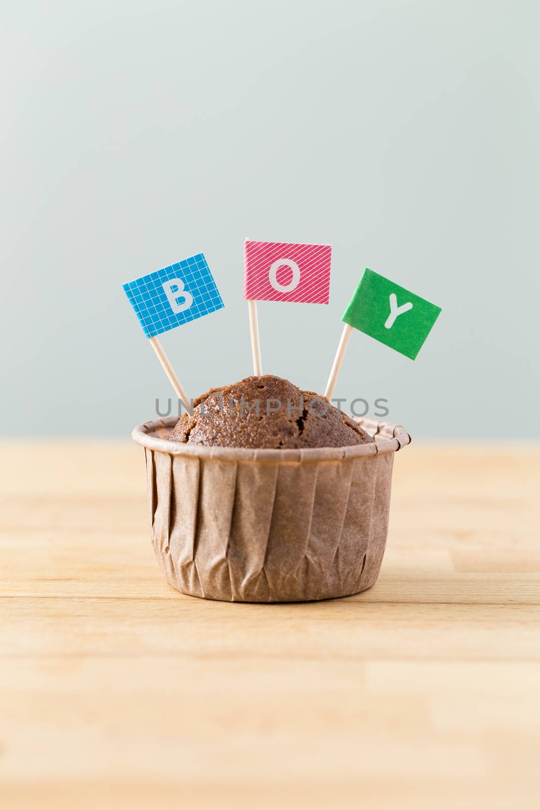 Chocolate muffins with small flag of a word boy