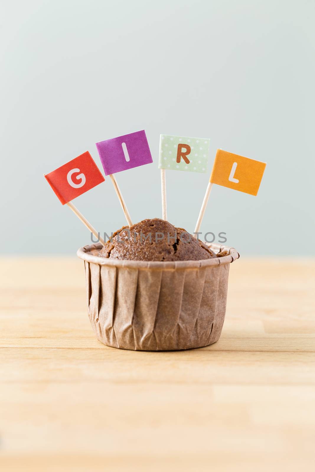 Chocolate muffins with small flag of a word girl