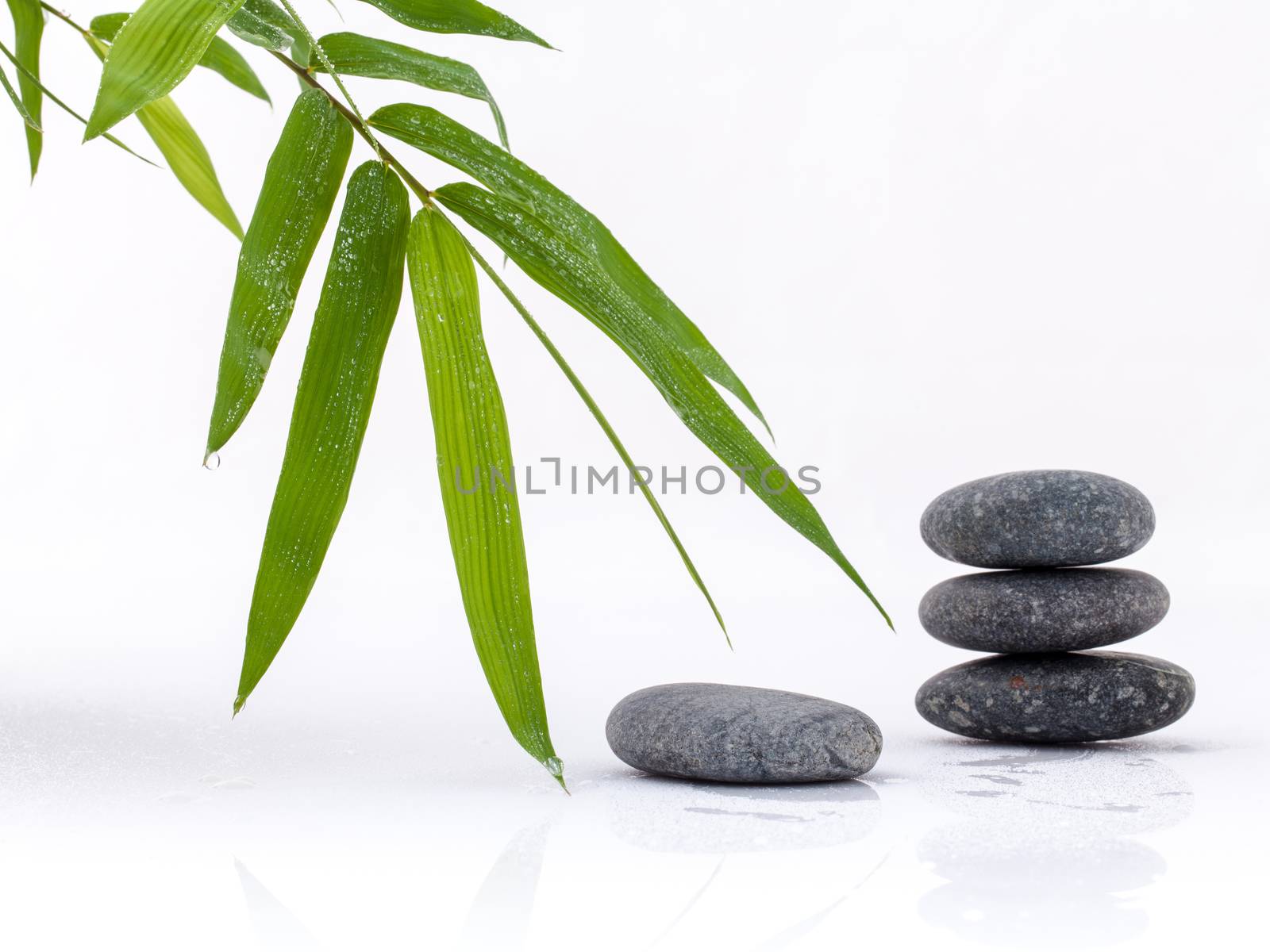 The stacked of Stones spa treatment scene and bamboo leaves with by kerdkanno