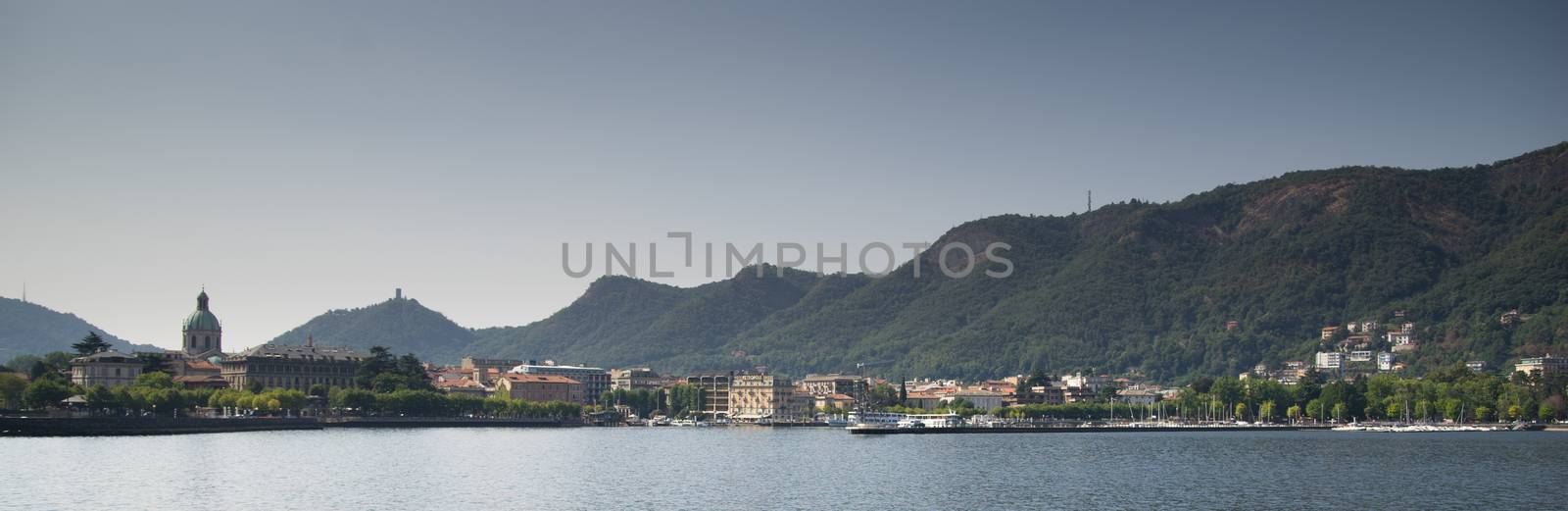 Como lake landscape with boats and water in summer travel