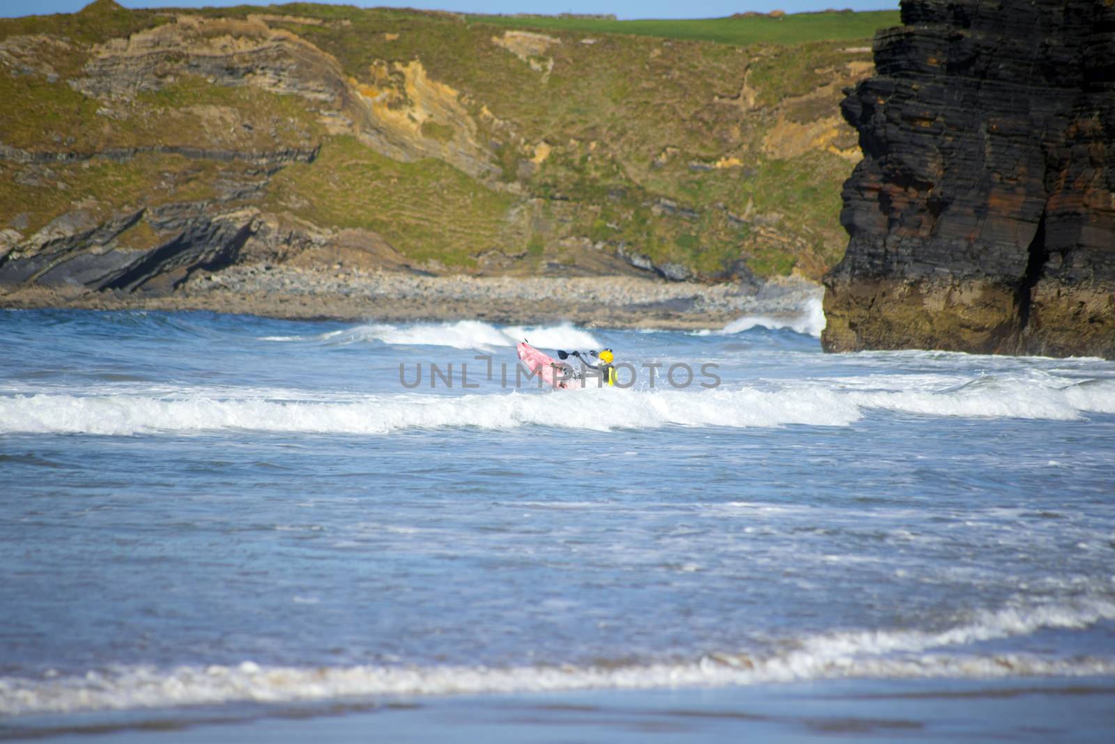 bright winter view of kayaker at ballybunion beach and cliffs on the wild atlantic way in ireland