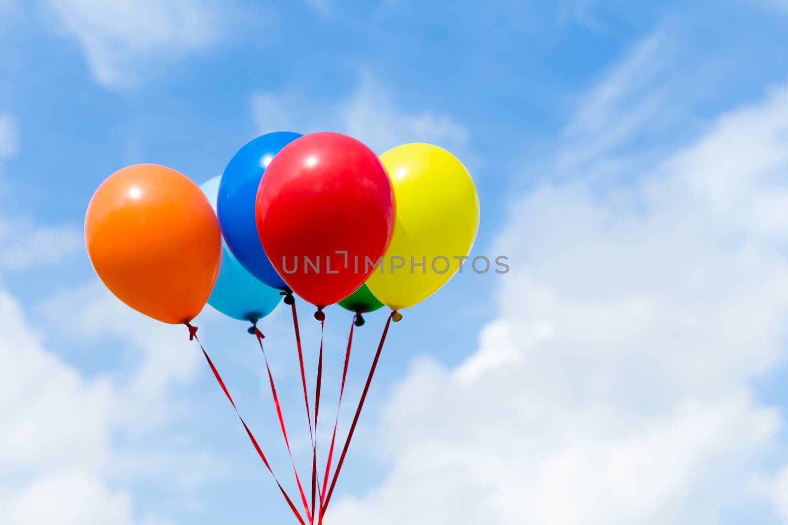 Bunch of colorful balloons in the blue sky by leungchopan