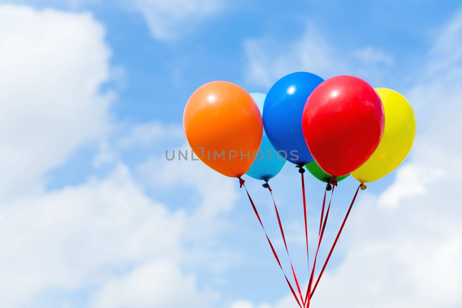 Bunch of colorful balloons in blue sky by leungchopan