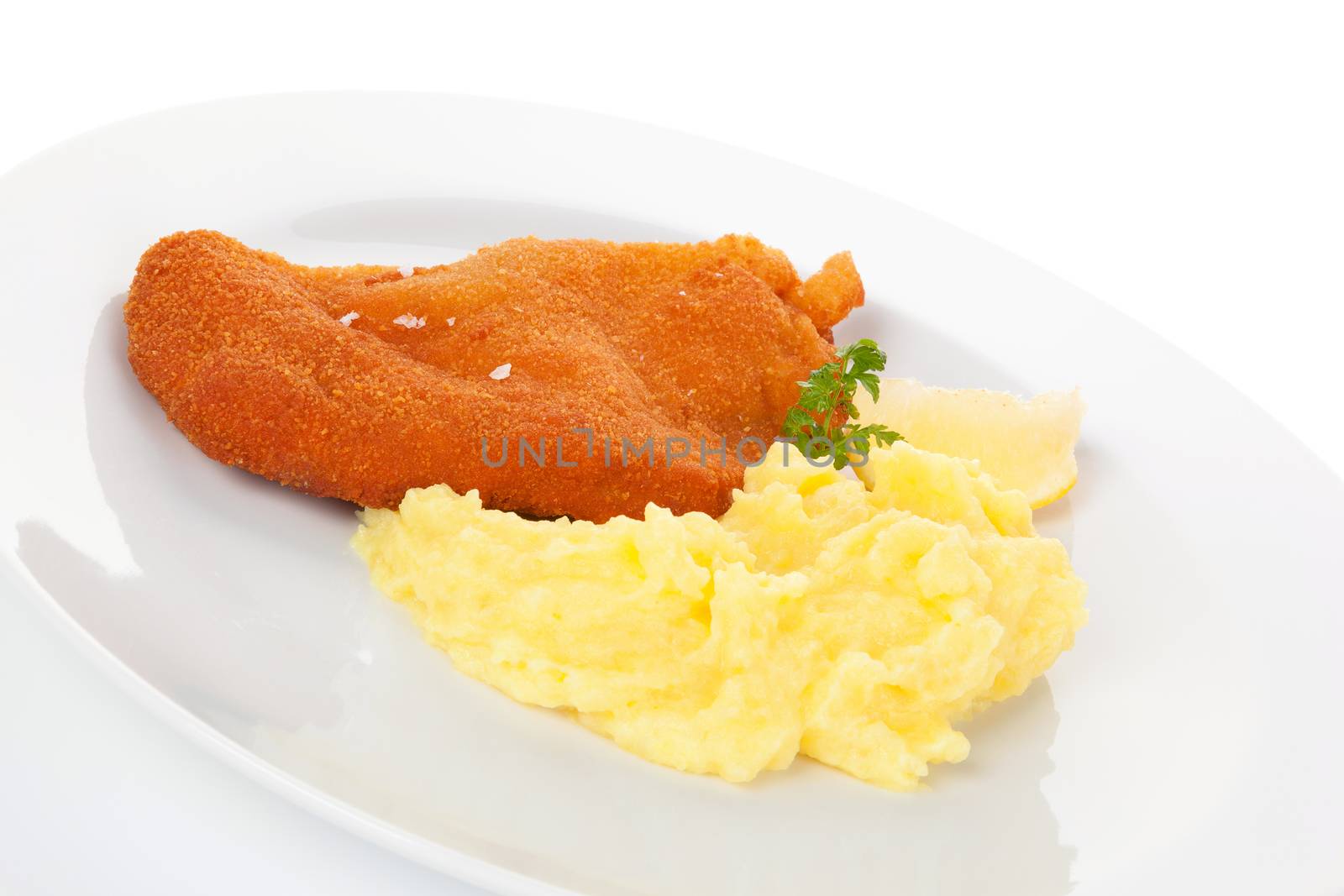 Delicious wiener schnitzel with mashed potatoes on plate on white background. Traditional european cuisine.