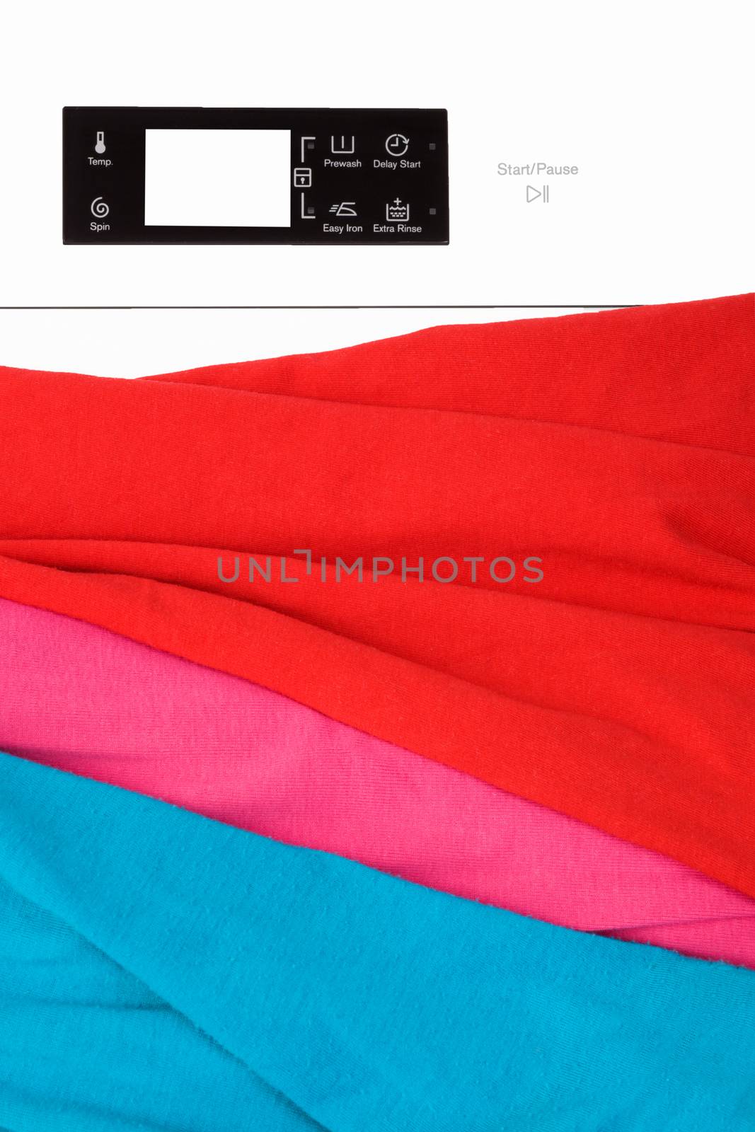 Laundry background. Top loading washing machine with natural organic detergent and colorful clothing, top view.