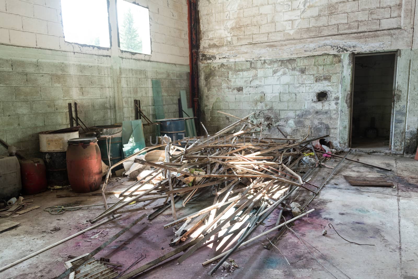 Interior of an abandoned cellar with details of wear and tear by time. You can see flashes of sunlight that enter through gaps and windows.