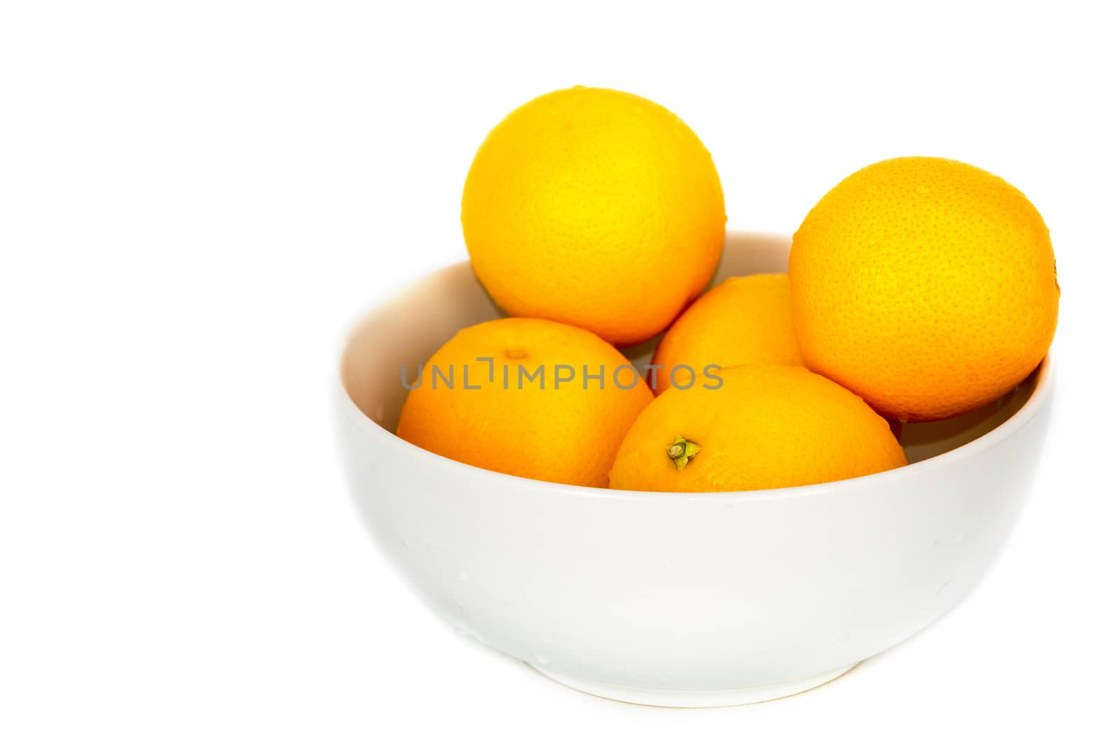 Orange fruit in white bowl on white background .