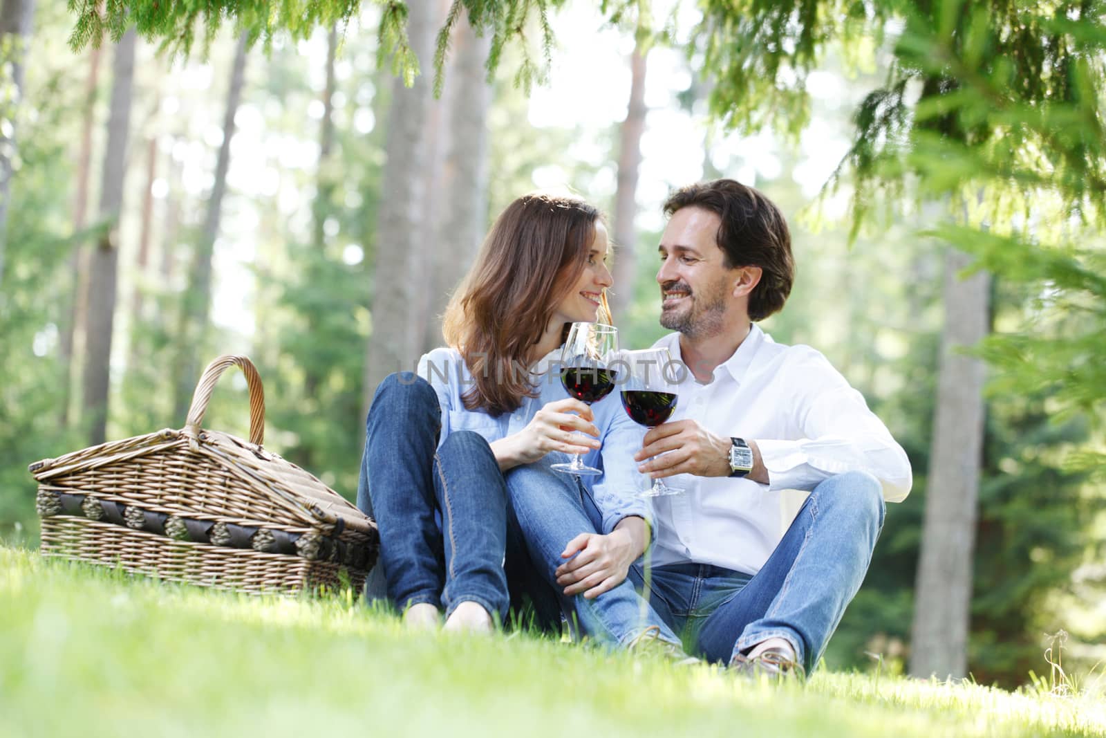 Young beautiful couple on picnic in summer park