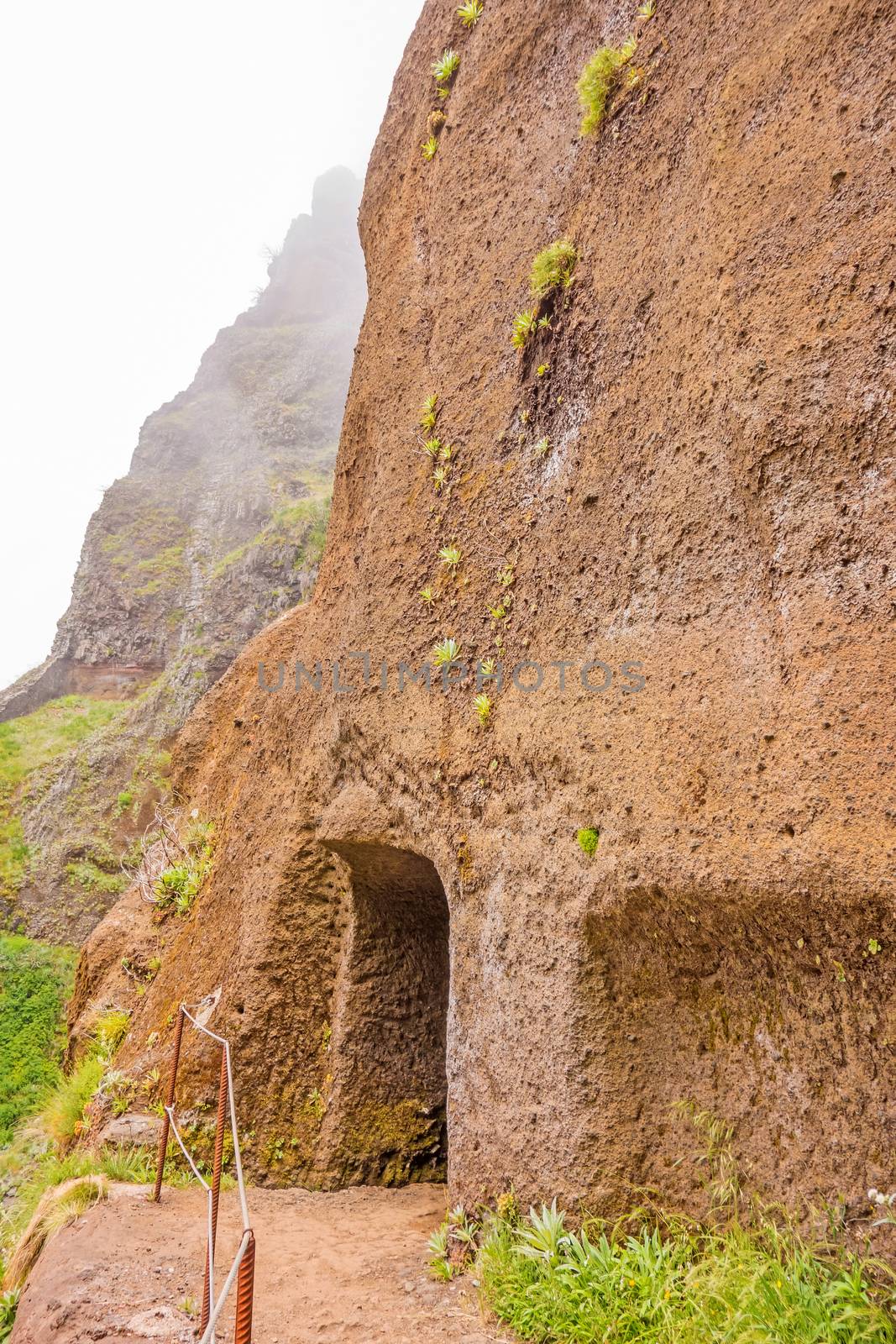 Hiking trail passage from mountain Pico Arieiro to Pico Ruivo, Madeira - tunnel entrance / exit
