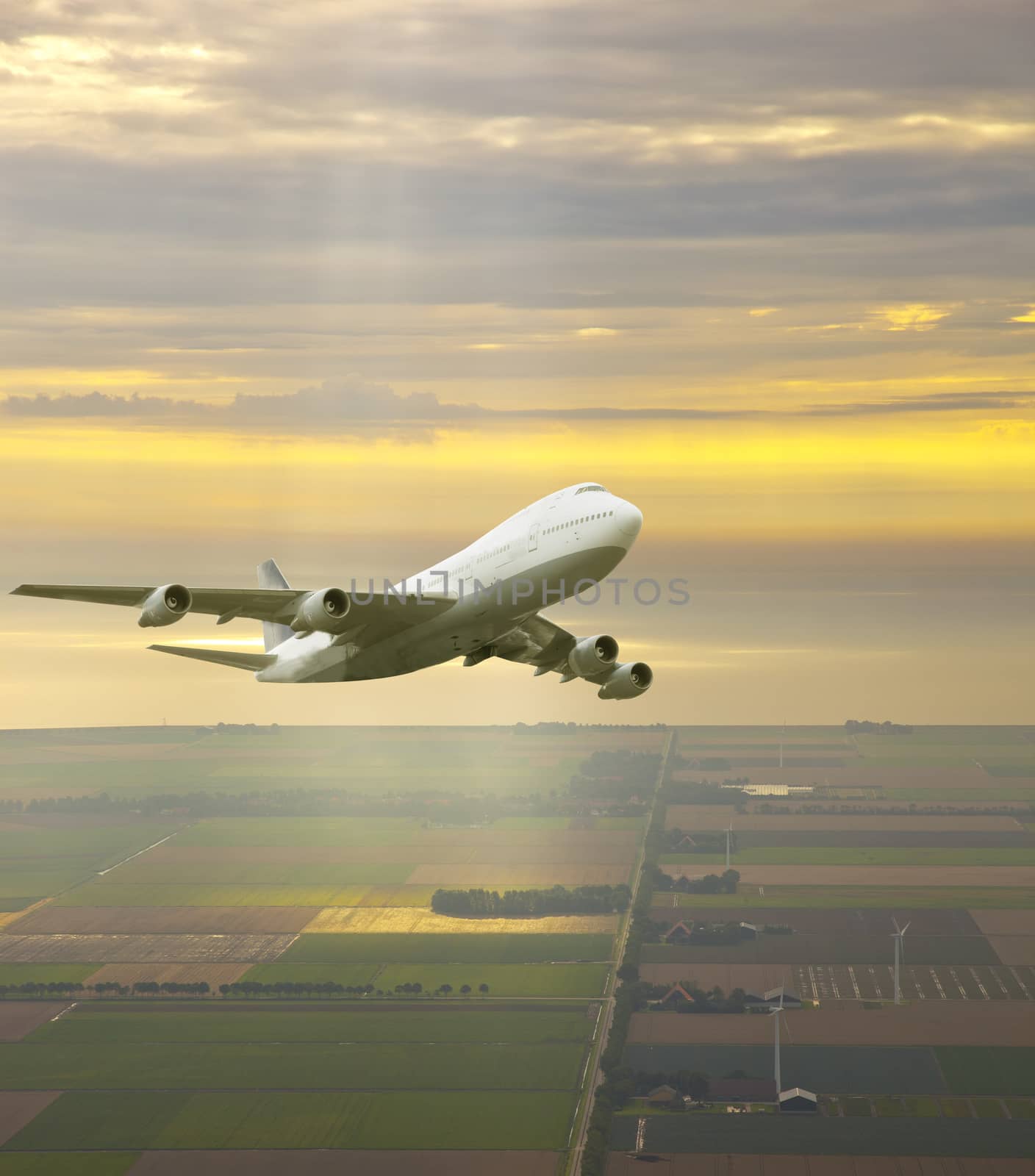 Airplane flying in beautiful yellow sky
