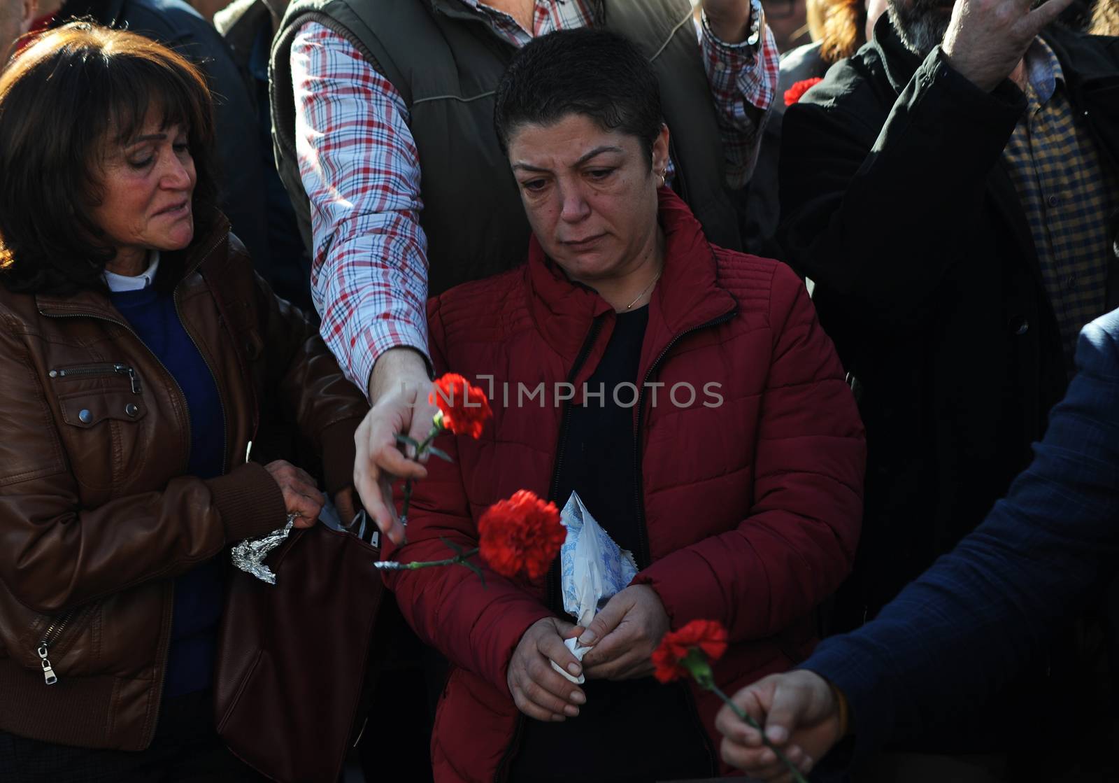TURKEY, Ankara: Mourners hold signs at a ceremony in Ankara, Turkey on November 7, 2015, honoring the victims of the twin explosions that left at least 97 people dead and more than 400 others injured on October 10.