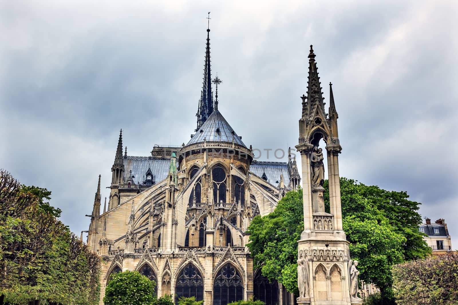 Rear Back Overcast Skies Flying Buttresses Notre Dame Cathedral Paris France.  Notre Dame was built between 1163 and 1250AD.  
