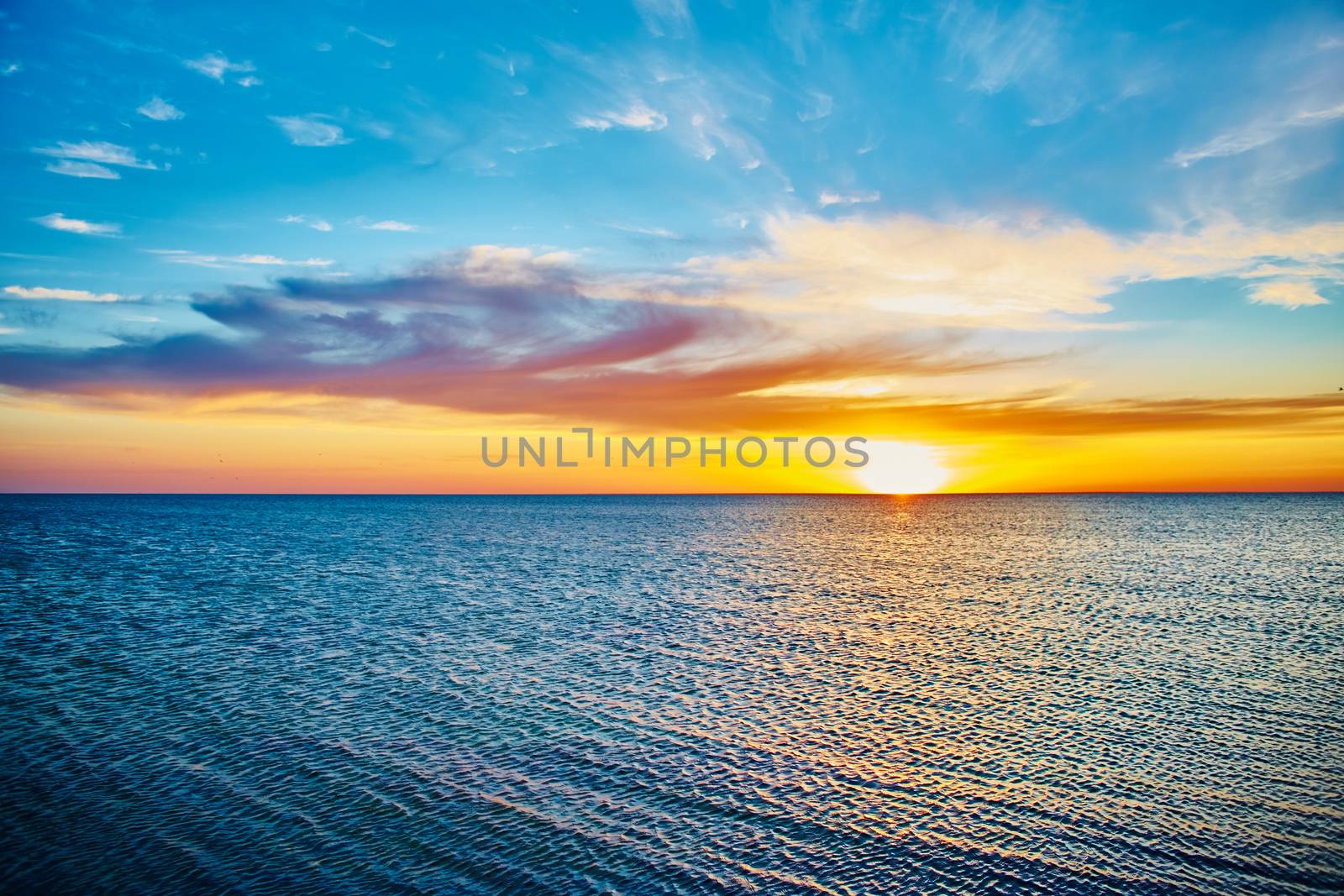 Sunset over the ocean by sarymsakov