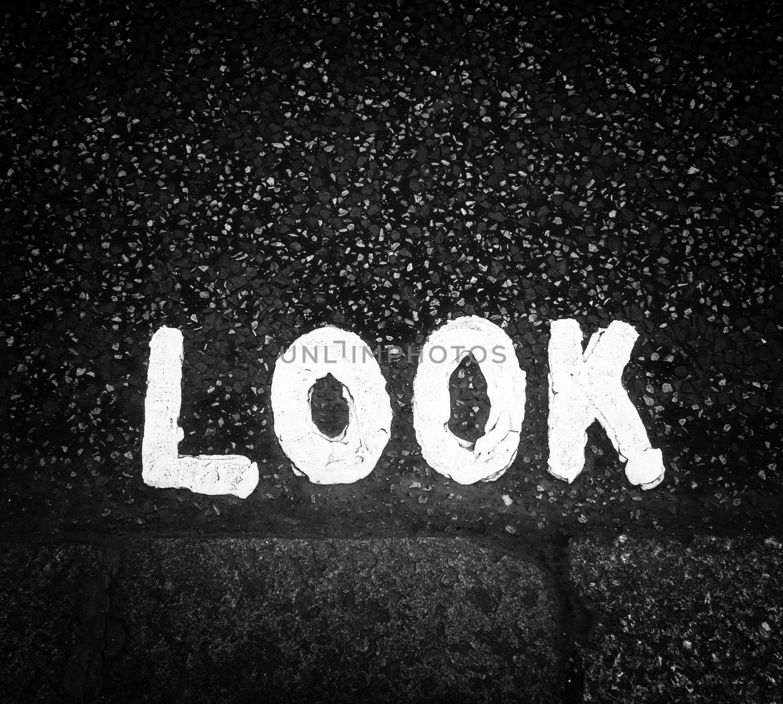 Look sign painted on the street in black and white