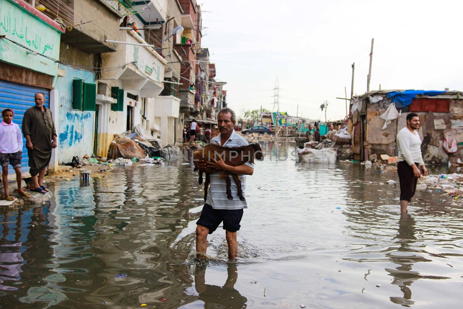EGYPT, Alexandria: People are seen in the flooding road after a torrential rain caused flood in the Kafr El Arab neigborhood in west of Alexandria, Egypt on November 07, 2015.