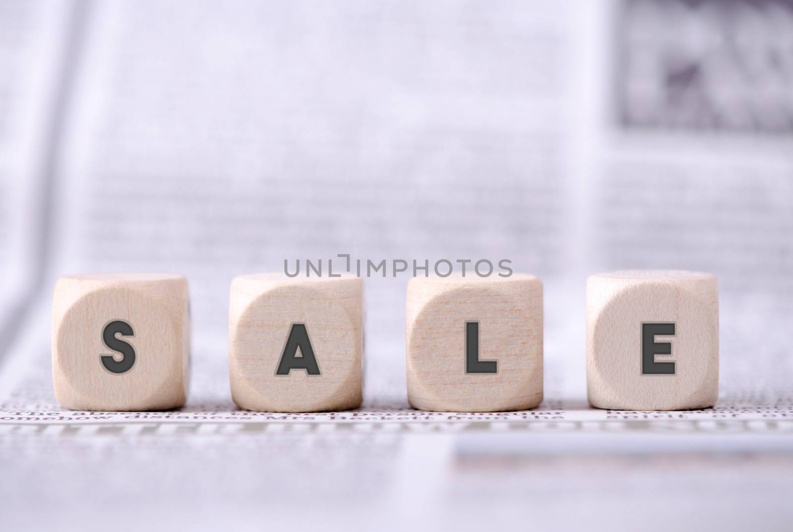 Four dice blocks with word sale written on.