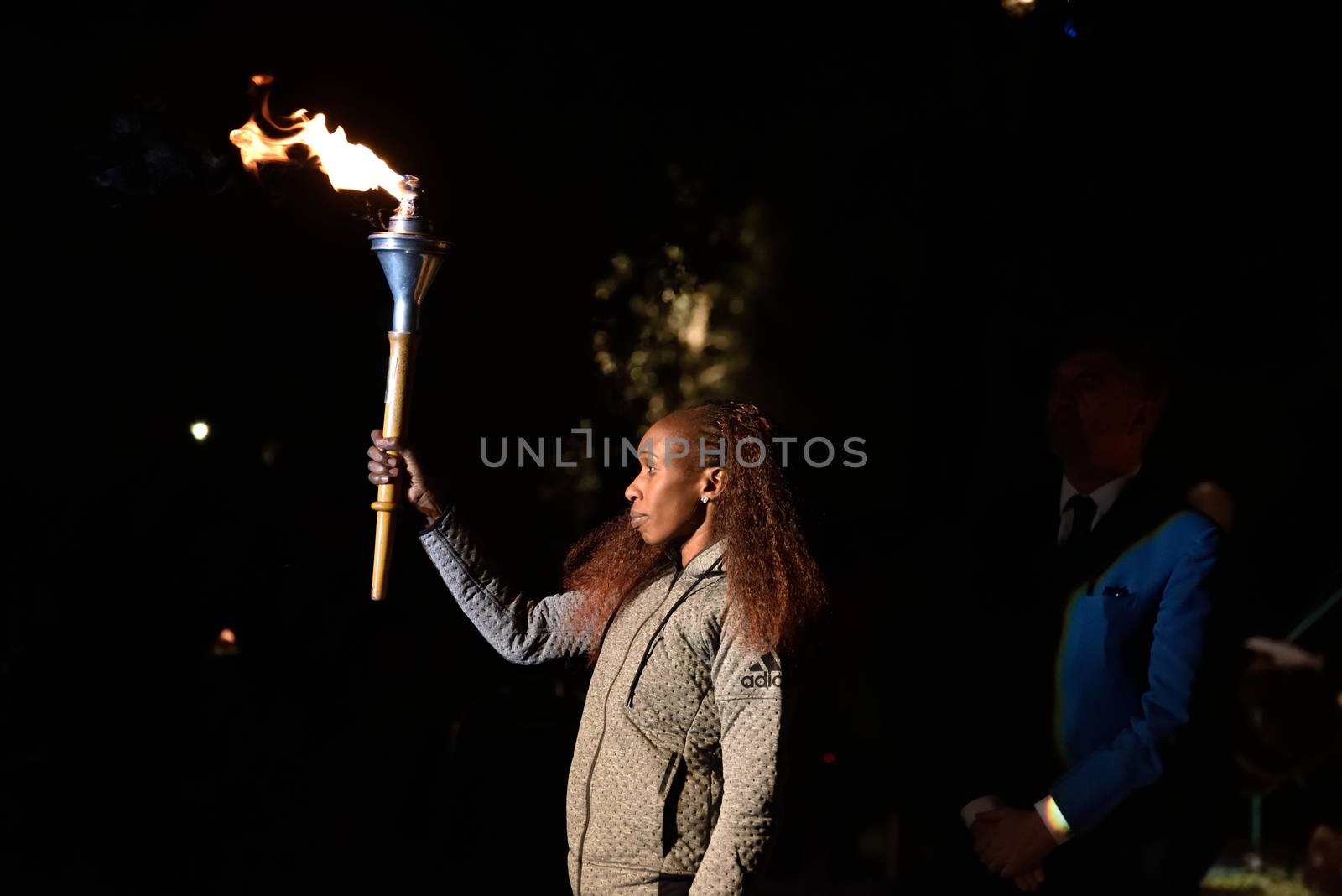 GREECE, Athens: Long-distance runner Gladys Cherono raises the Marathon flame Torch during the Ceremony of the Lighting of the Marathon Flame at the Marathon Tomb in Athens, Greece, on November 7, 2015.