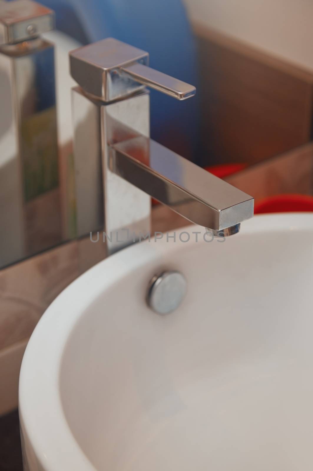 Sink and water tap. Horizontal close-up photo