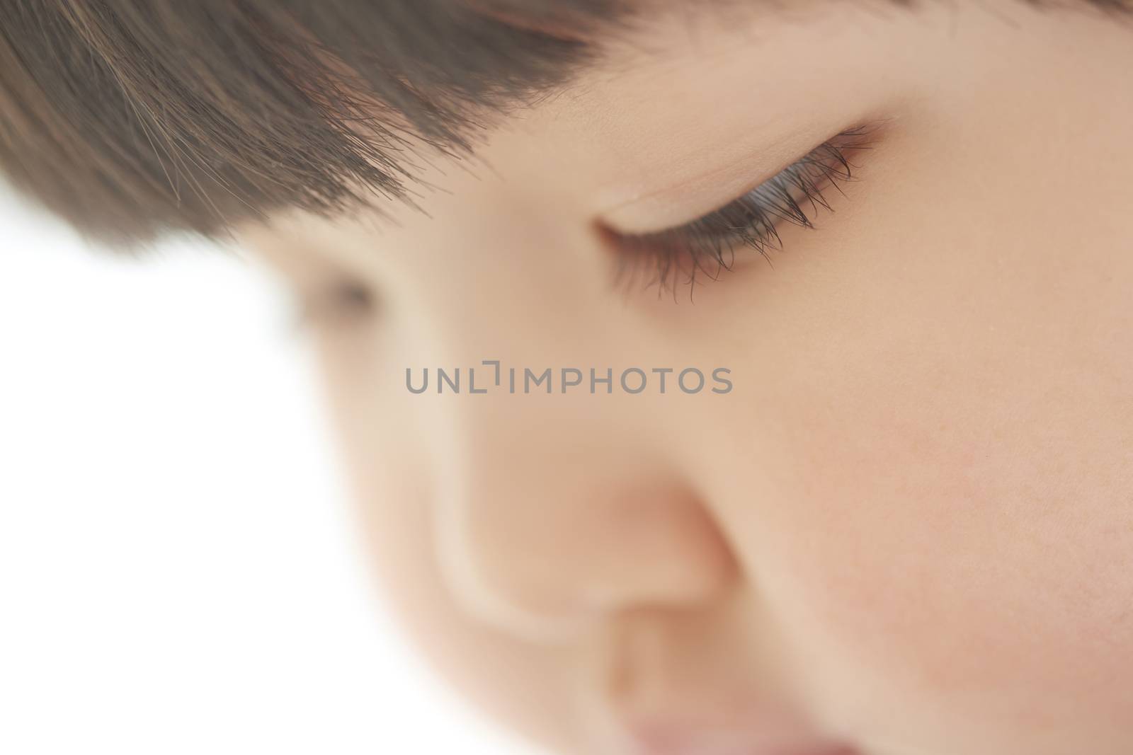 Close-up photo of pensive child looking down