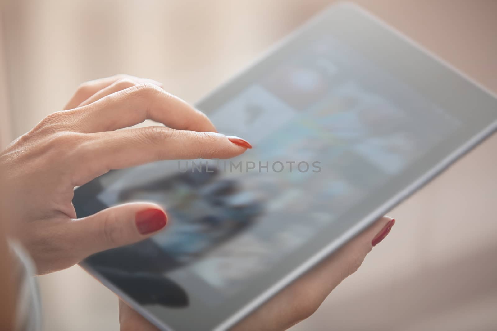 Hands of woman using digital tablet