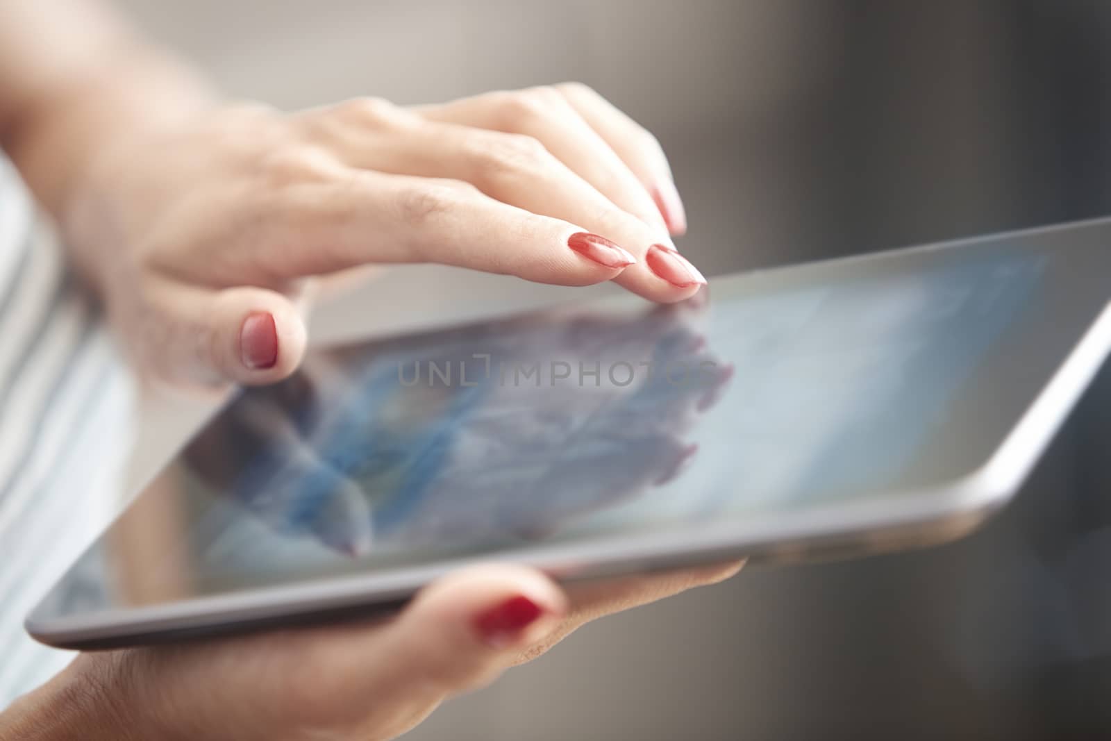 Hands of woman using digital tablet