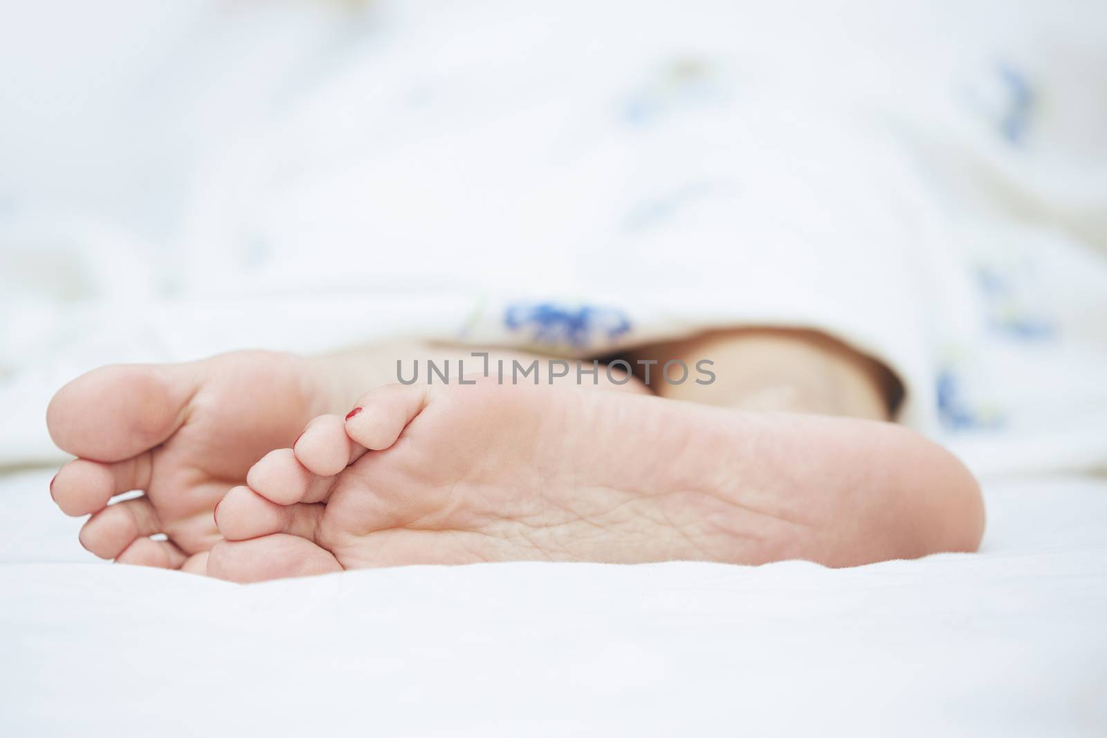 Feet of sleeping woman. Horizontal photo