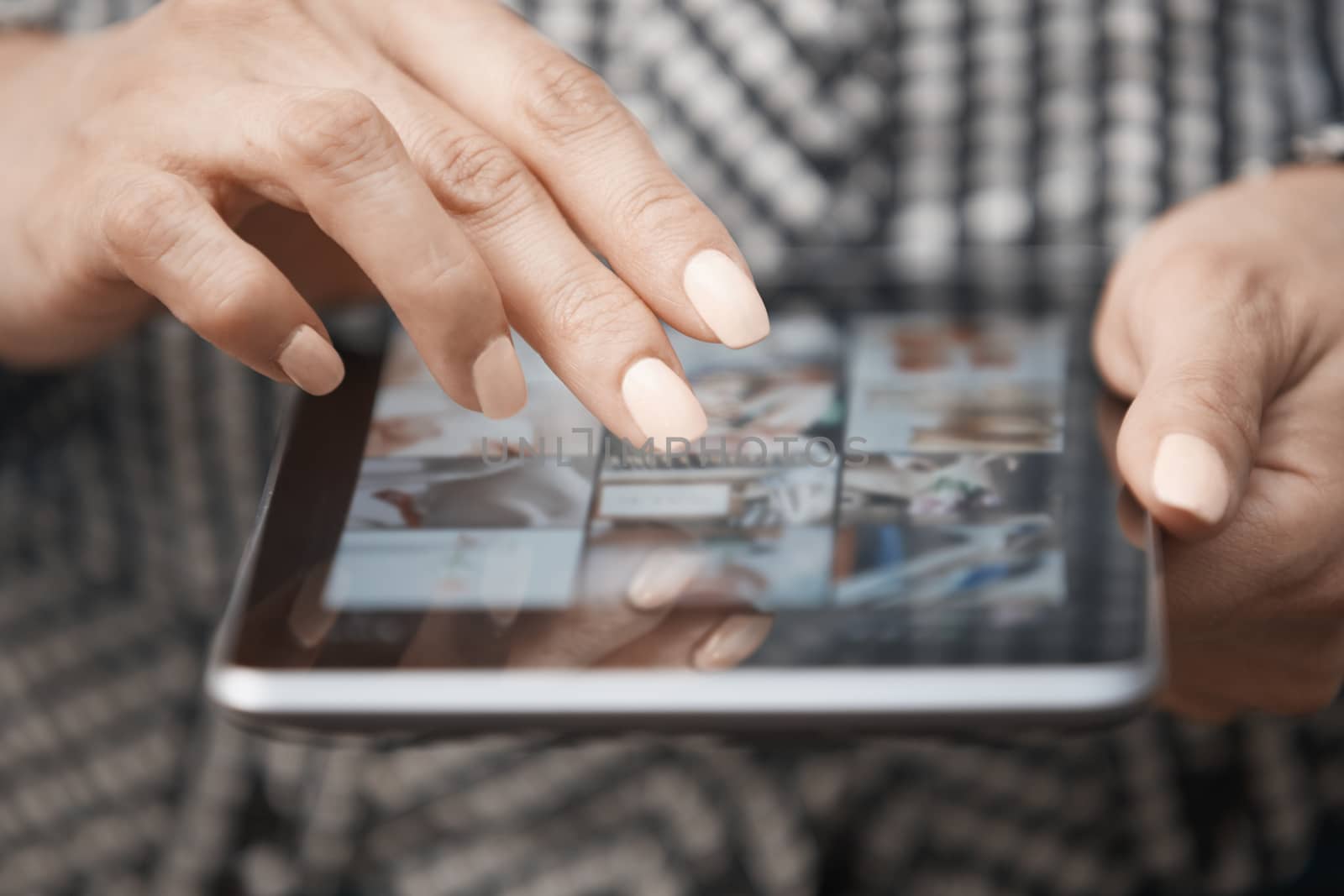 Hands of woman using digital tablet