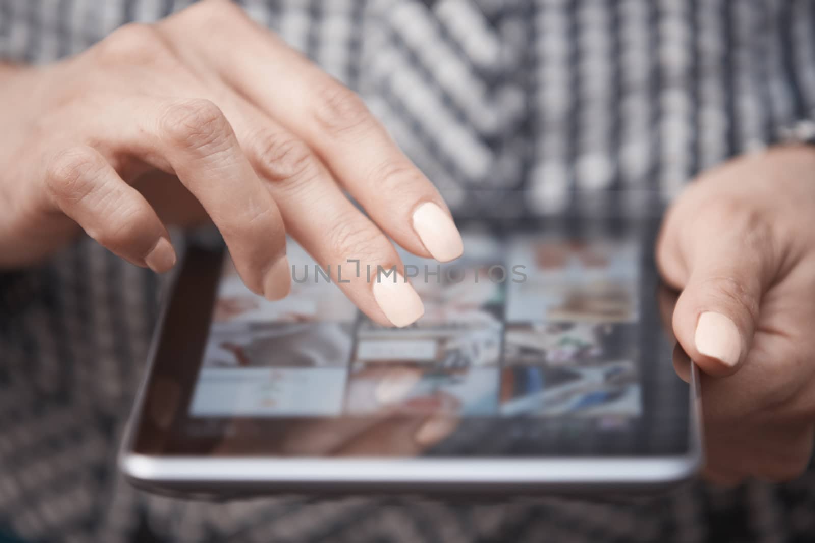 Hands of woman using digital tablet