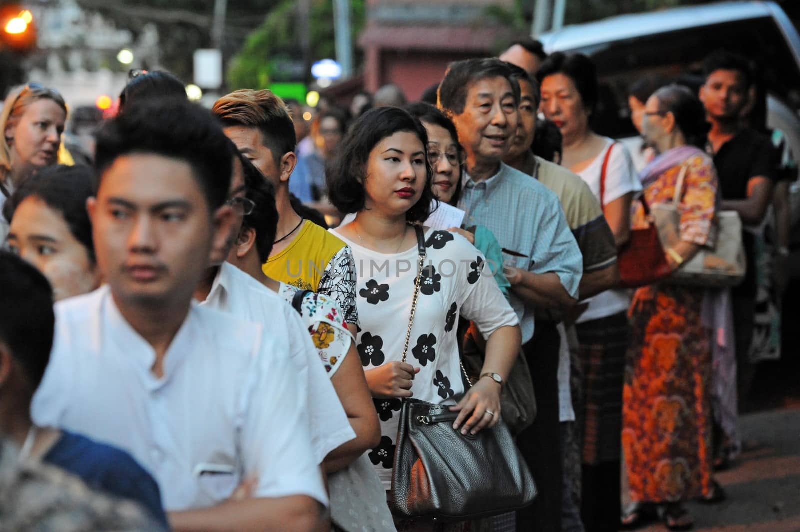 MYANMAR, Yangon: Voters line up in front of a polling station in Yangon, Myanmar, on November 8, 2015. Myanmar goes to the polls in an historic election that could thrust opposition leader Aung San Suu Kyi's pro-democracy party into power and pull the country away from the grip of the military. 