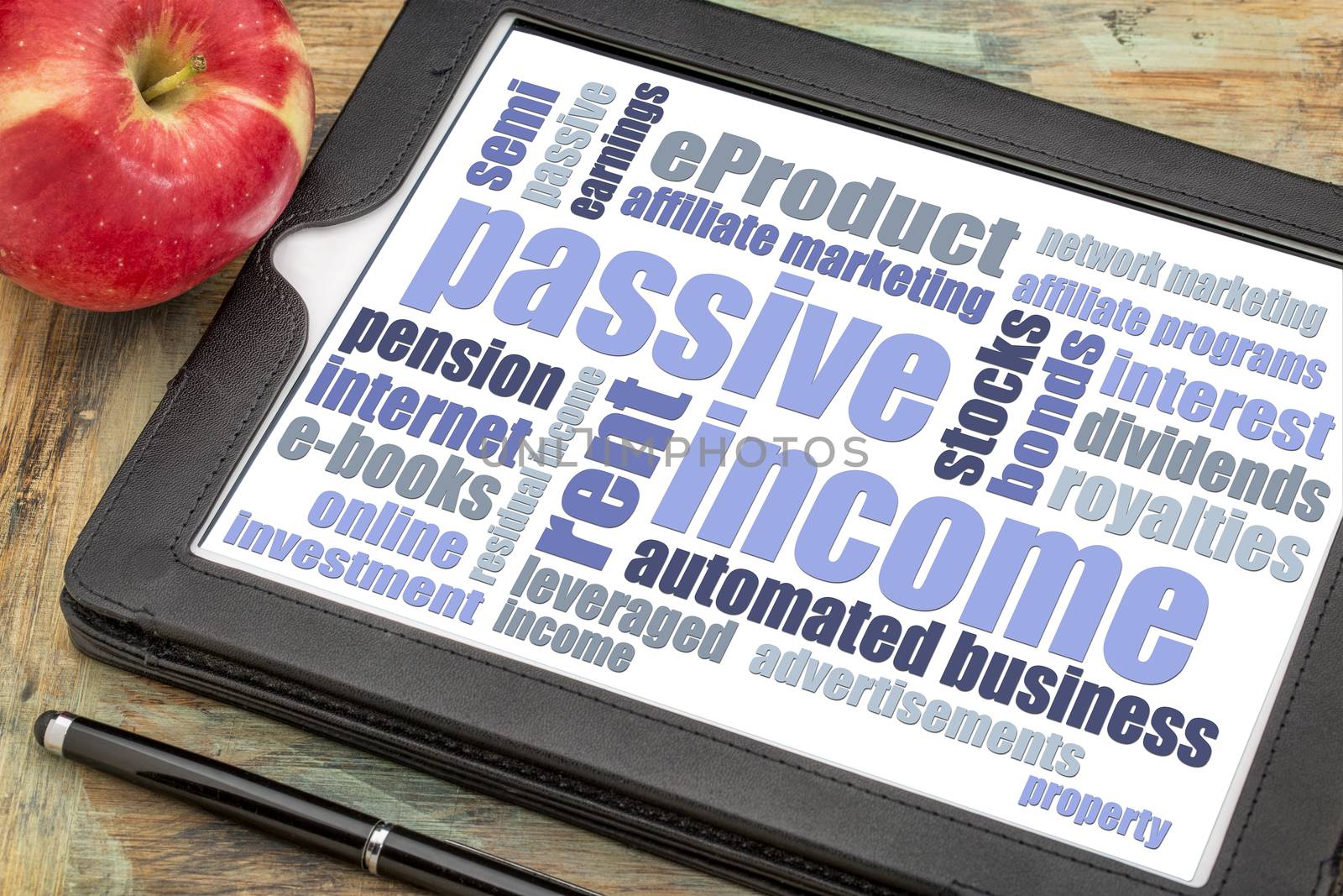 passive income word cloud on a tablet by PixelsAway