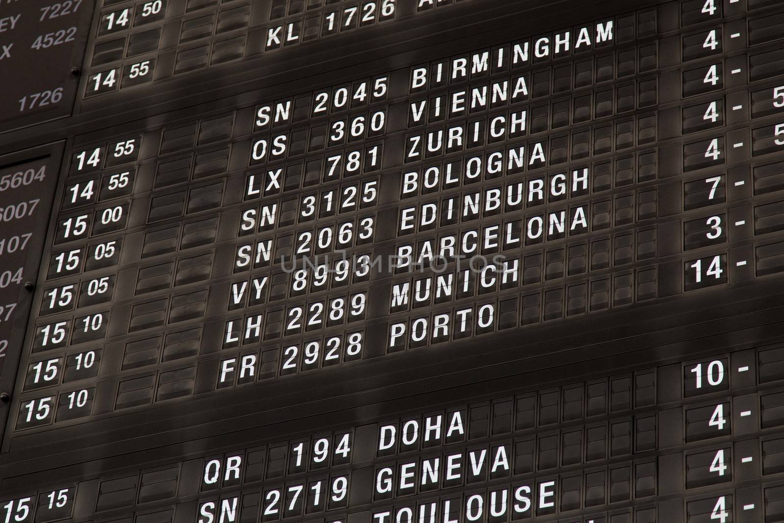 Airport departure board in terminal with flight information