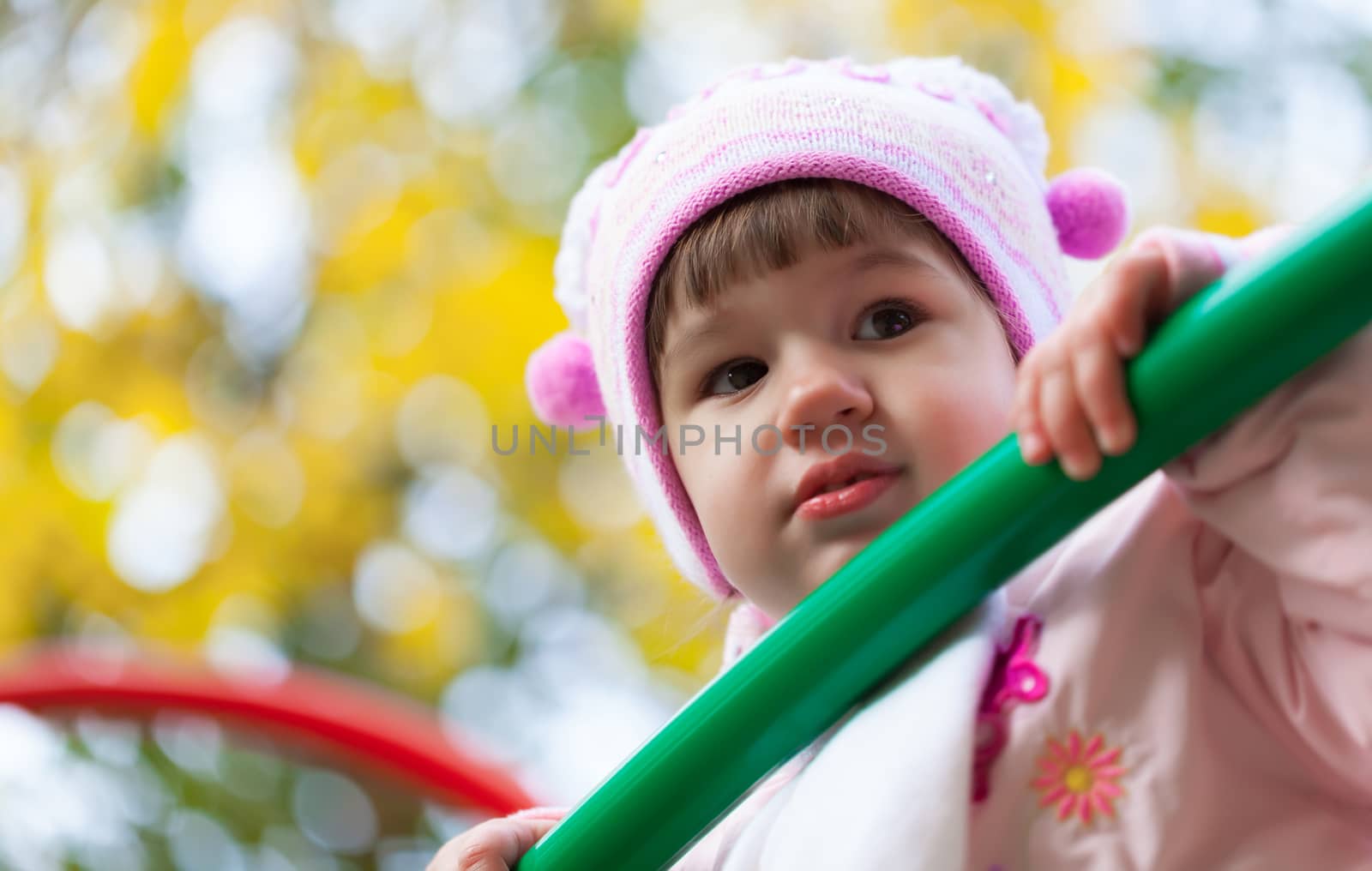 portrait of a little girl playing outdoors in autumn