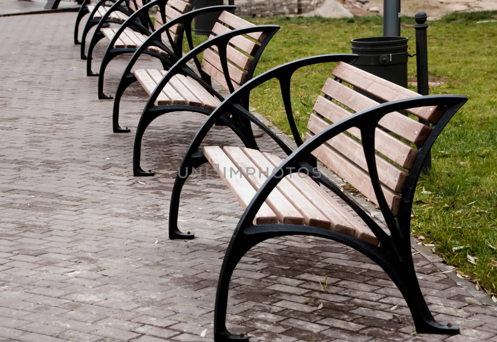  wooden bench in the city park by alexx60