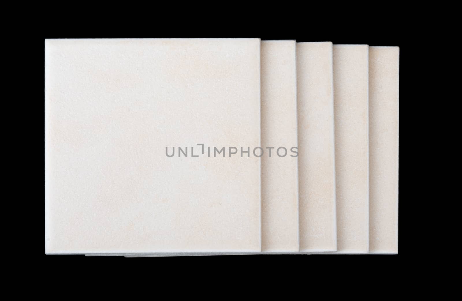 Pile of tiles on black backround, side view
