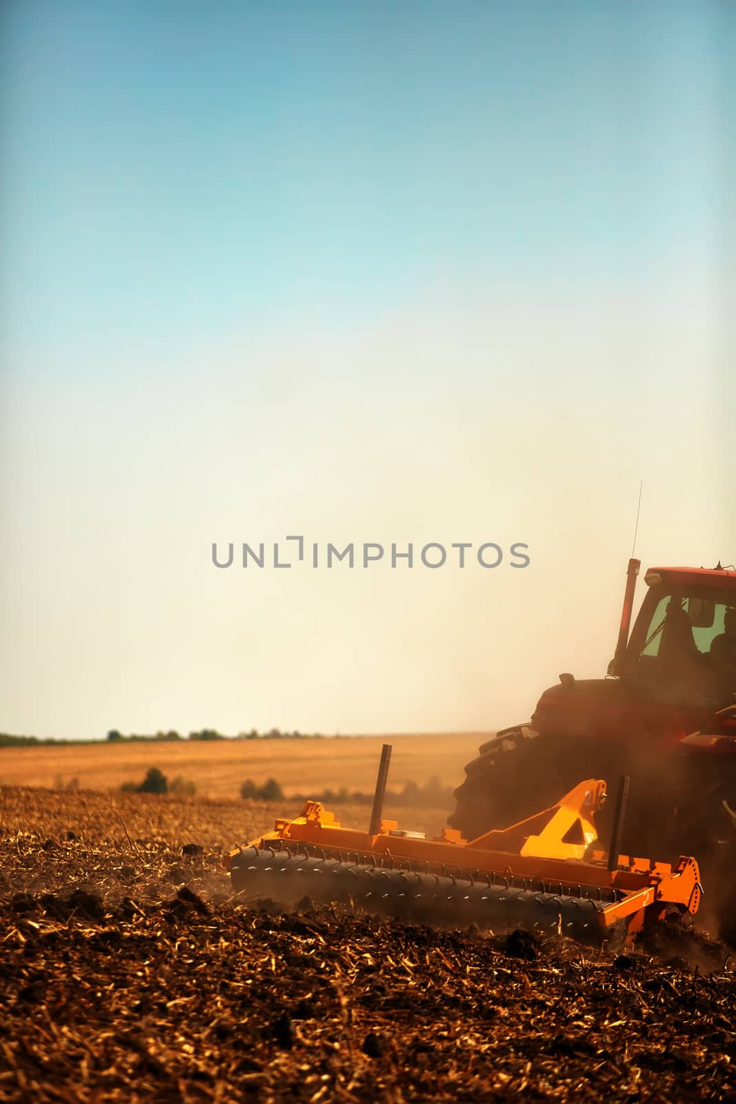 Agricultural Landscape. Tractor working on the field. by sarymsakov