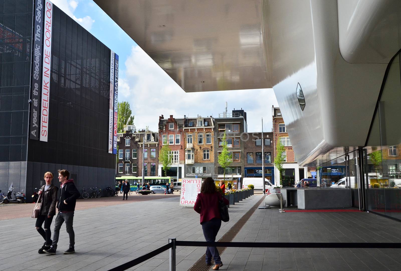 Amsterdam, Netherlands - May 6, 2015: People visit famous Stedelijk Museum in Amsterdam located in the museum park, Netherlands on May 6, 2015