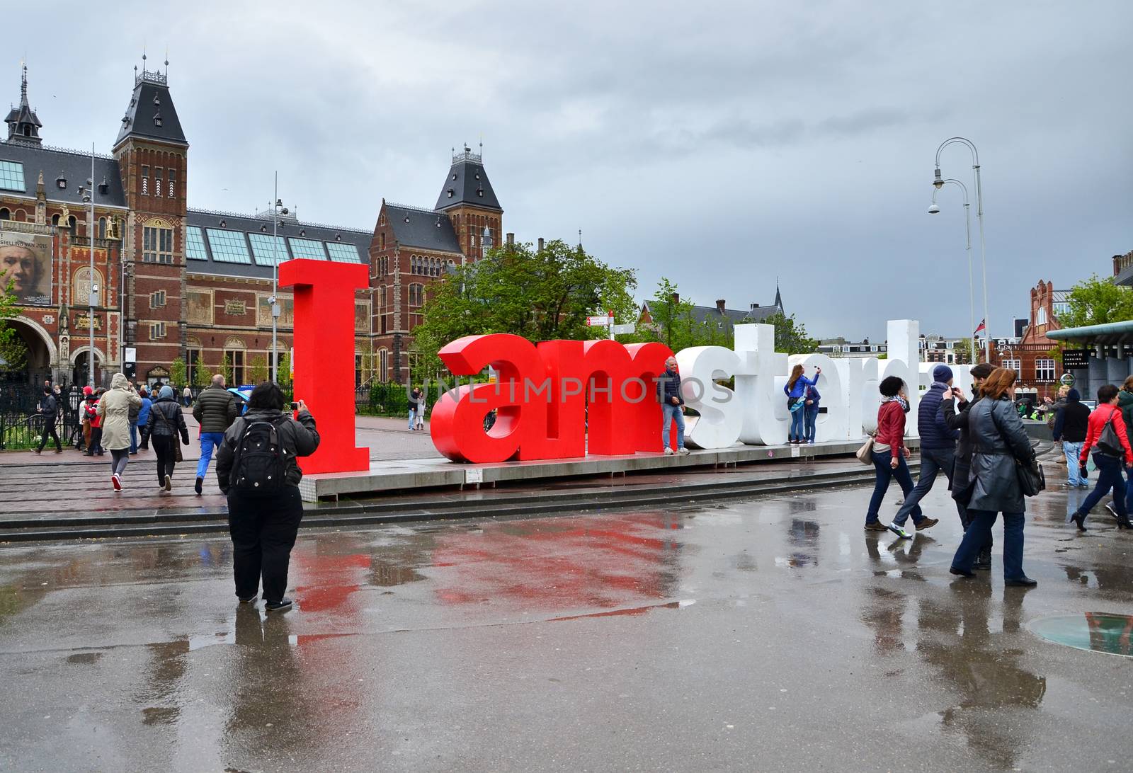 Amsterdam, Netherlands - May 6, 2015: Tourists at the famous sign "I amsterdam" at the Rijksmuseum in Amsterdam on May 6, 2015. Amsterdam is a capital and largest city of Netherlands.