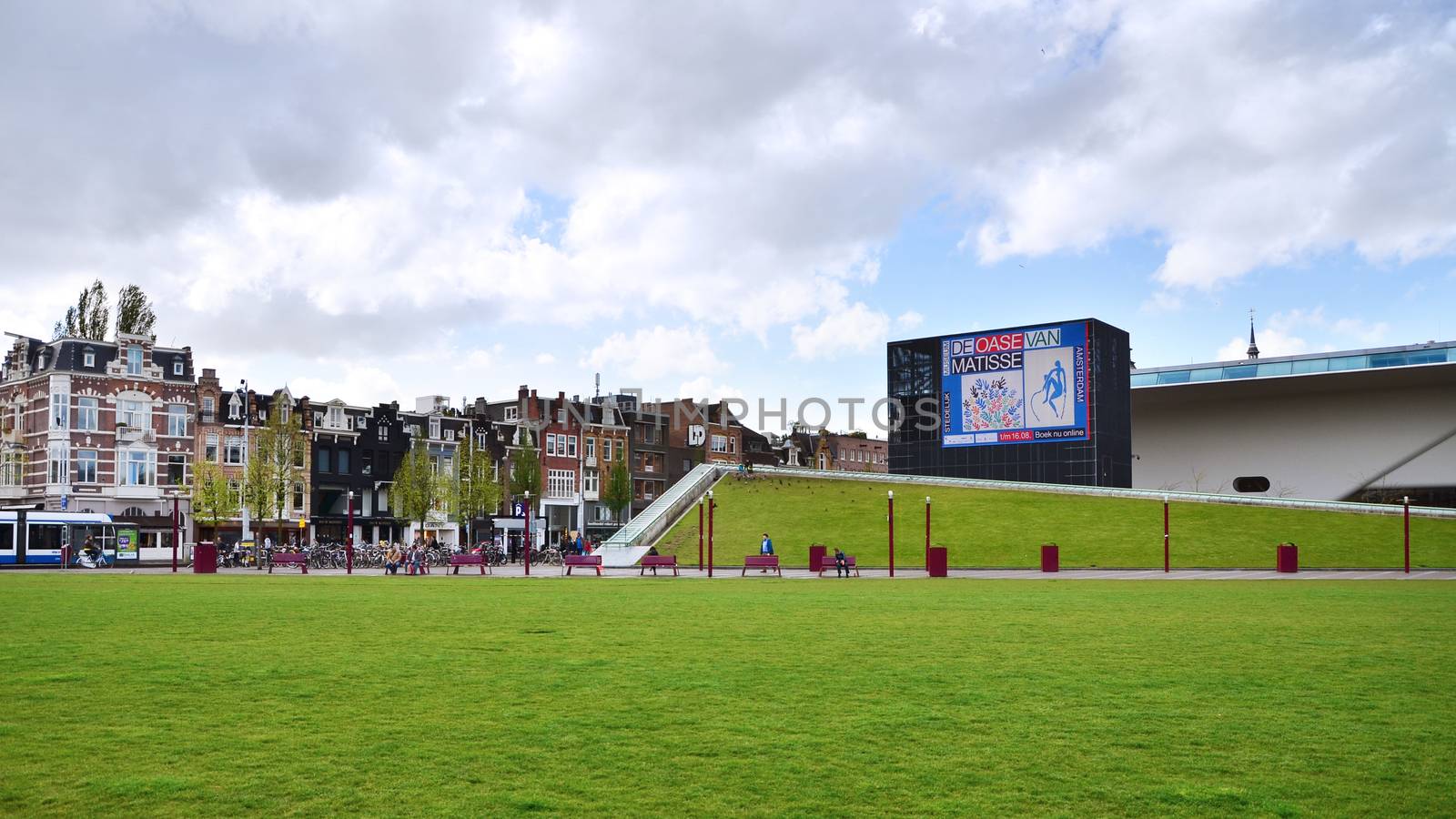 Amsterdam, Netherlands - May 6, 2015: Tourist visit Stedelijk Museum in Amsterdam located in the museum park, Netherlands on May 6, 2015