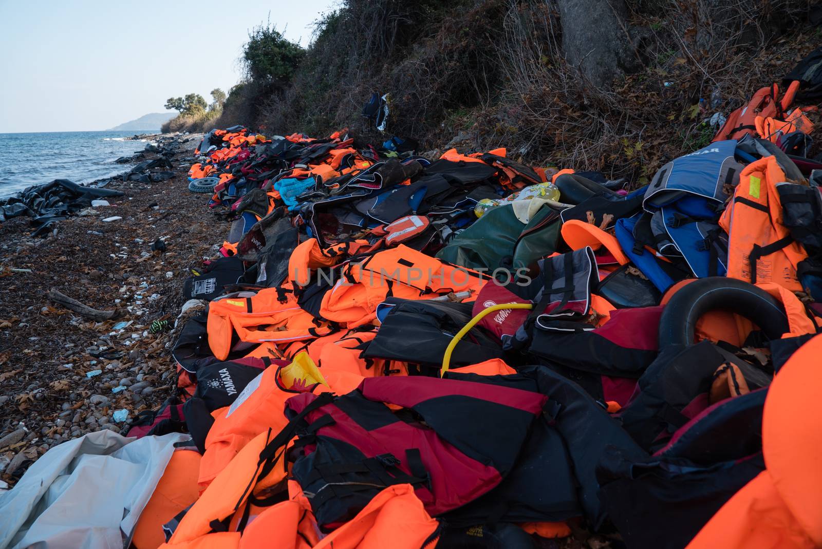 GREECE, Lesbos: The northern coast of the Greek island of Lesbos is covered with thousands of orange life jackets on November 8, 2015. A fresh group of refugees arrive under the supervision of the Greek and Turkish coast guards.  