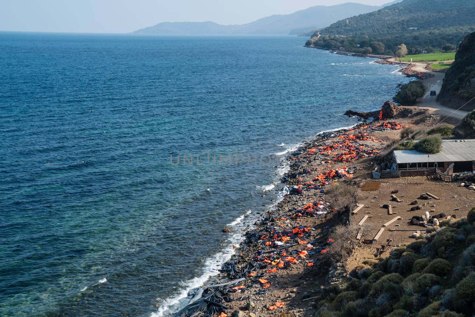 GREECE, Lesbos: The northern coast of the Greek island of Lesbos is covered with thousands of orange life jackets on November 8, 2015. A fresh group of refugees arrive under the supervision of the Greek and Turkish coast guards.  