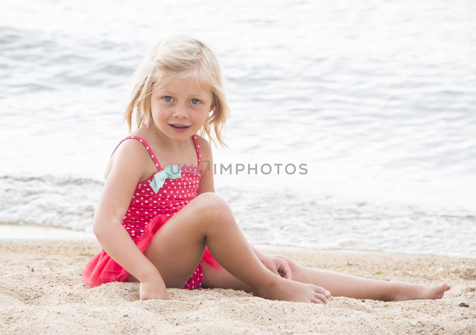 Cute Little Girl Sunbathing on the Beach