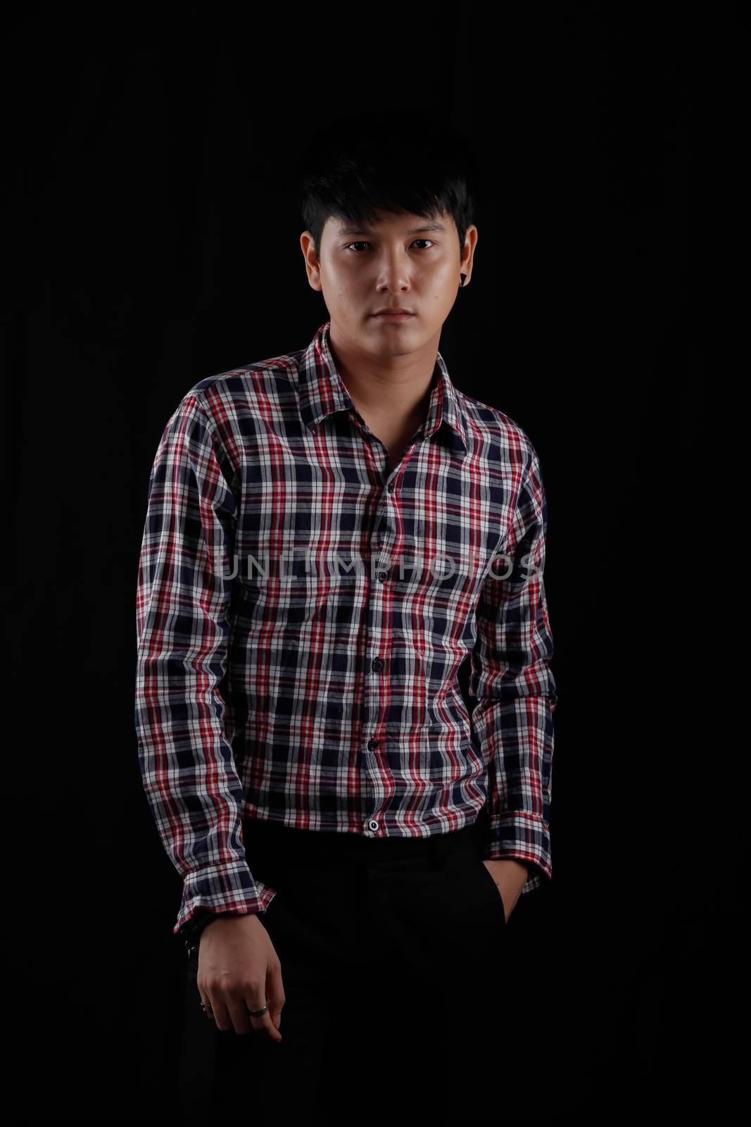 Portrait of Asian young man on black background