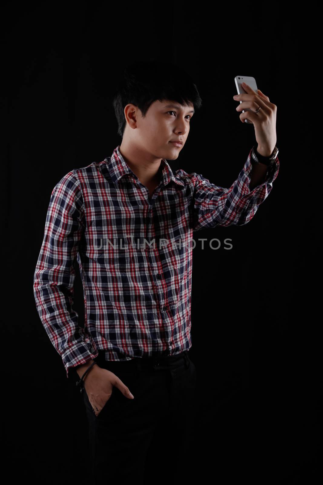 Portrait of Asian young man on black background