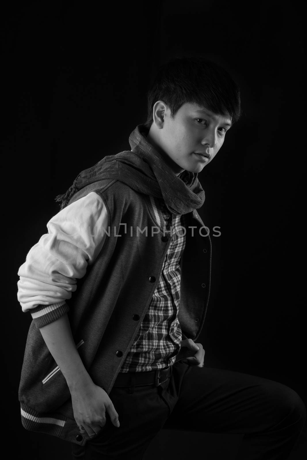 Portrait of Asian young man on black background