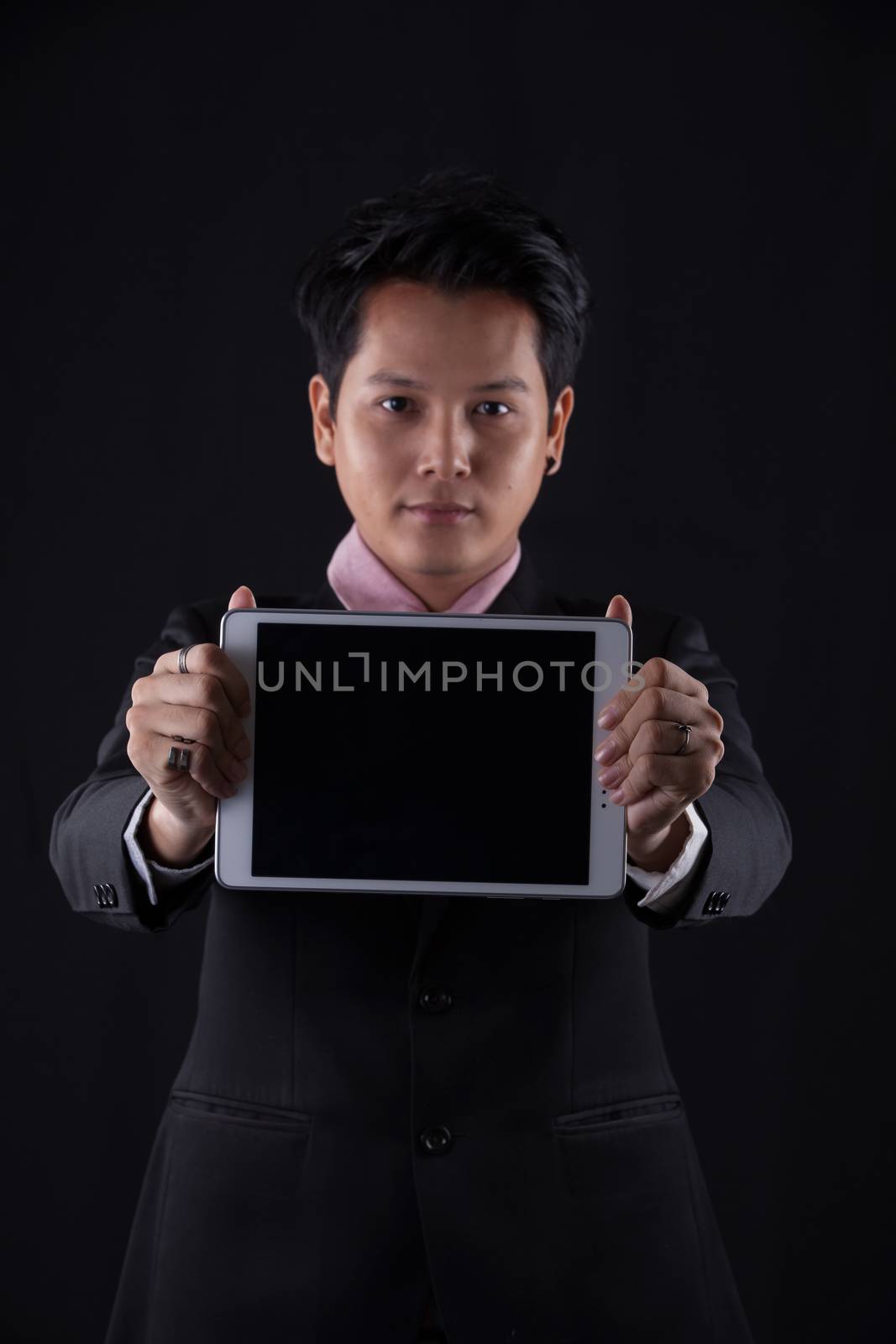 Portrait of Asian young man on black background